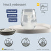 Glas mit sich auflösendem Elektrolytpulver auf Tablett, Schale mit Pulver im Vordergrund, Icons für vegan, glutenfrei, laktosefrei und Text zur verbesserten Rezeptur, Geschmack und Löslichkeit.